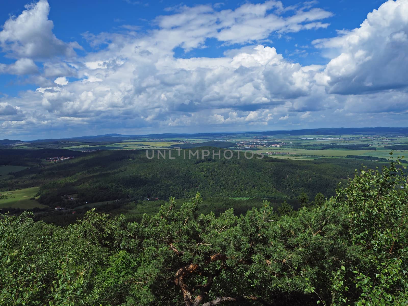 view from top of the mountain in Jeseniky - hills, trees, villages and blue sky and white clouds