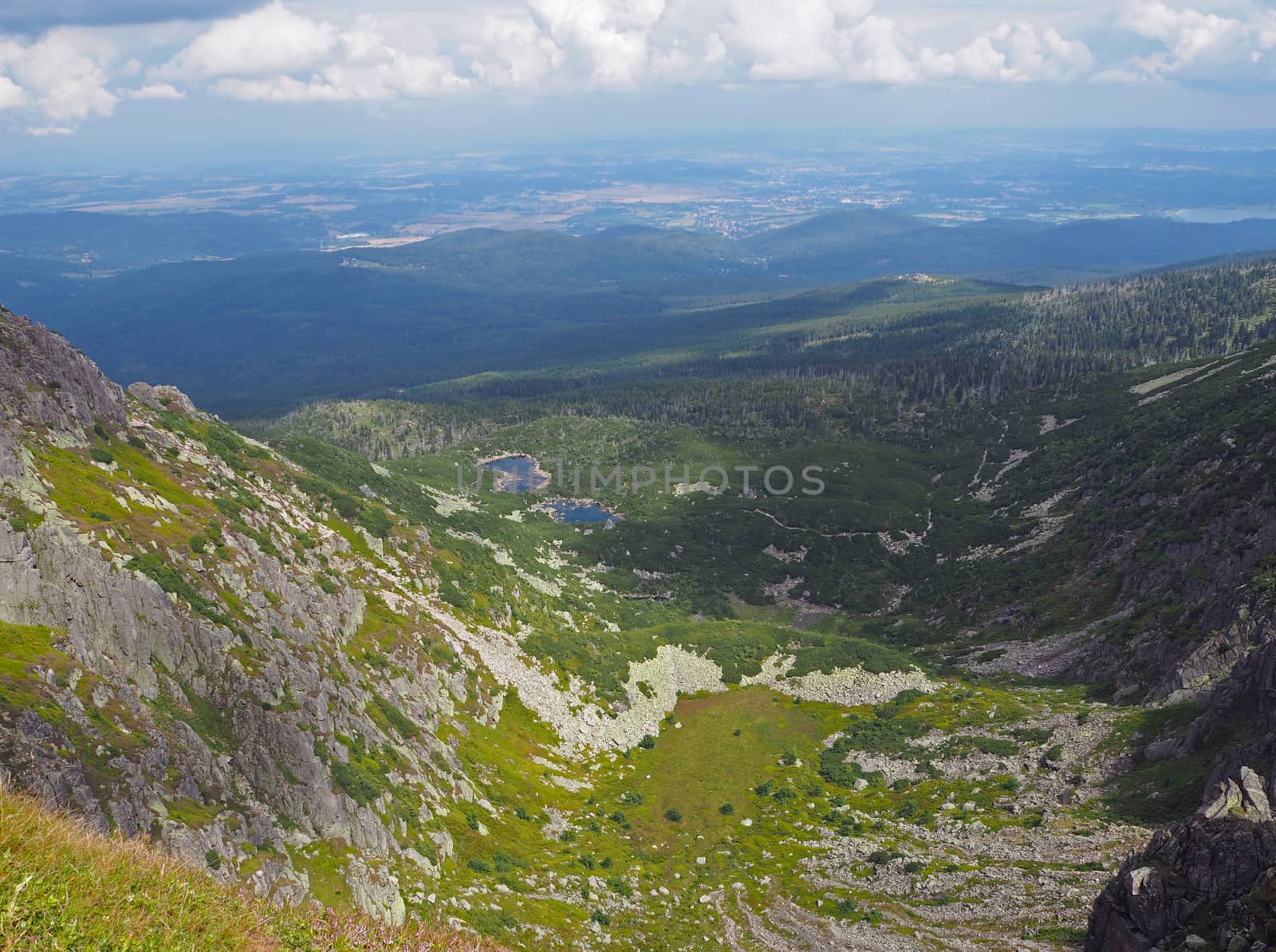 Krkonose mountains scenery with two mountain lakes, green grass and rocks on Czech Poland borders