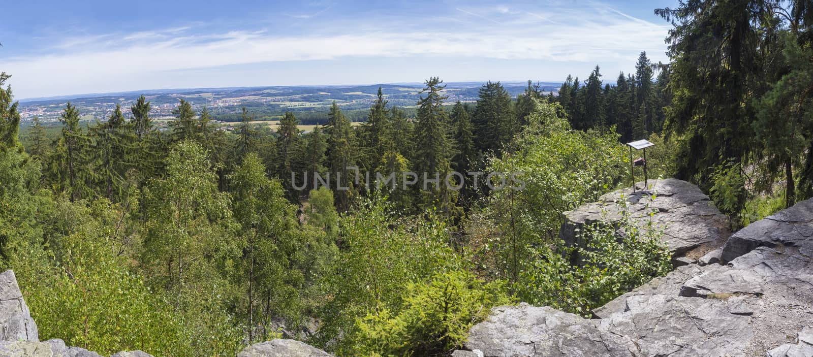 Panoramic view from look out in Brdy mountain hills, with green trees, rocks town and blue sky, Czech Republic by Henkeova