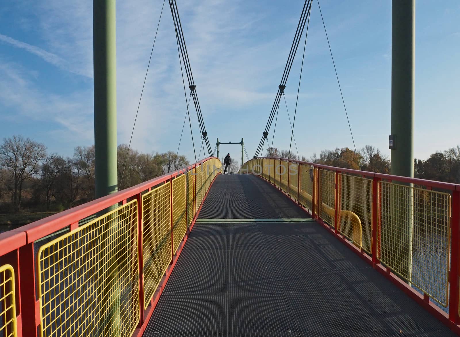 footbridge on steel rope over the river Elbe with standing man o by Henkeova