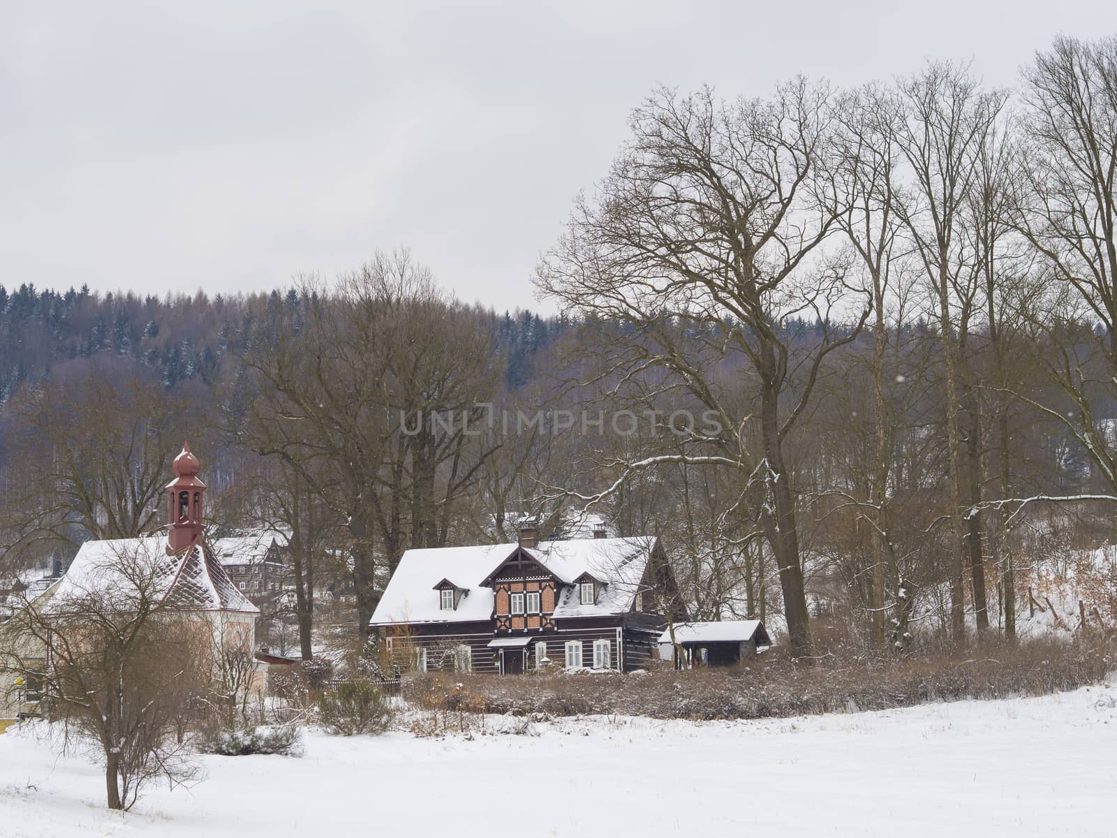 winter view on village travnik with chapel, timbered cottage nad by Henkeova