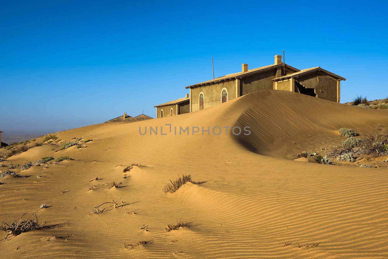 Abandoned houses in Kolmanskop ghost town located in the desert of southern Namibia near the town of Luderitz.