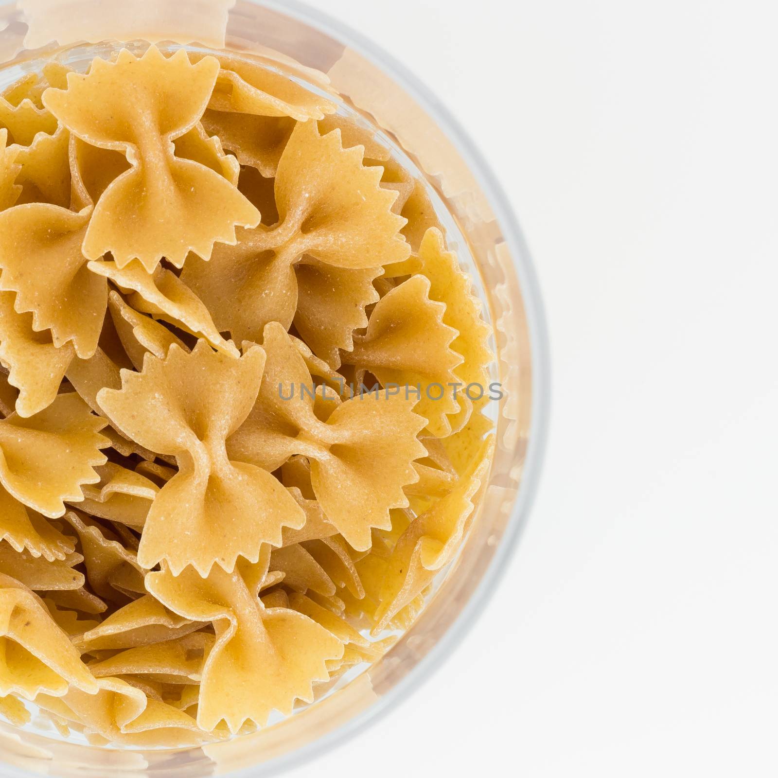 Detail of a plate of whole wheat pasta with copyspace.