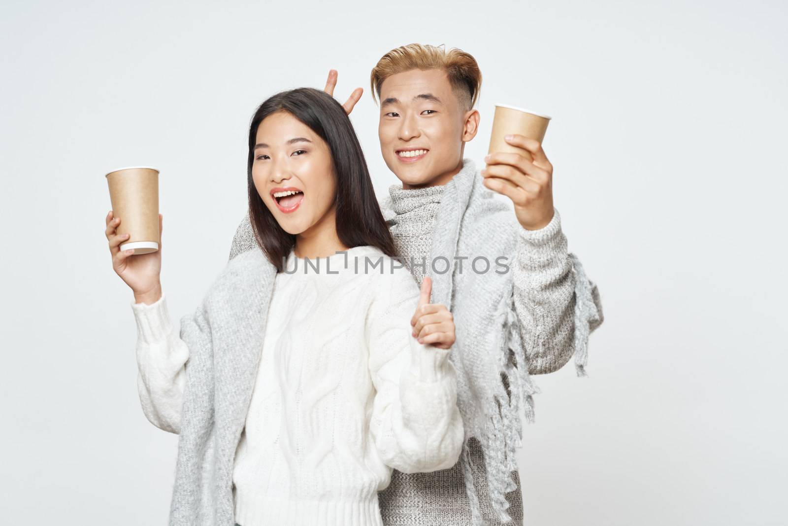 A cheerful young couple of Asian appearance elegant style glass with a lifestyle drink