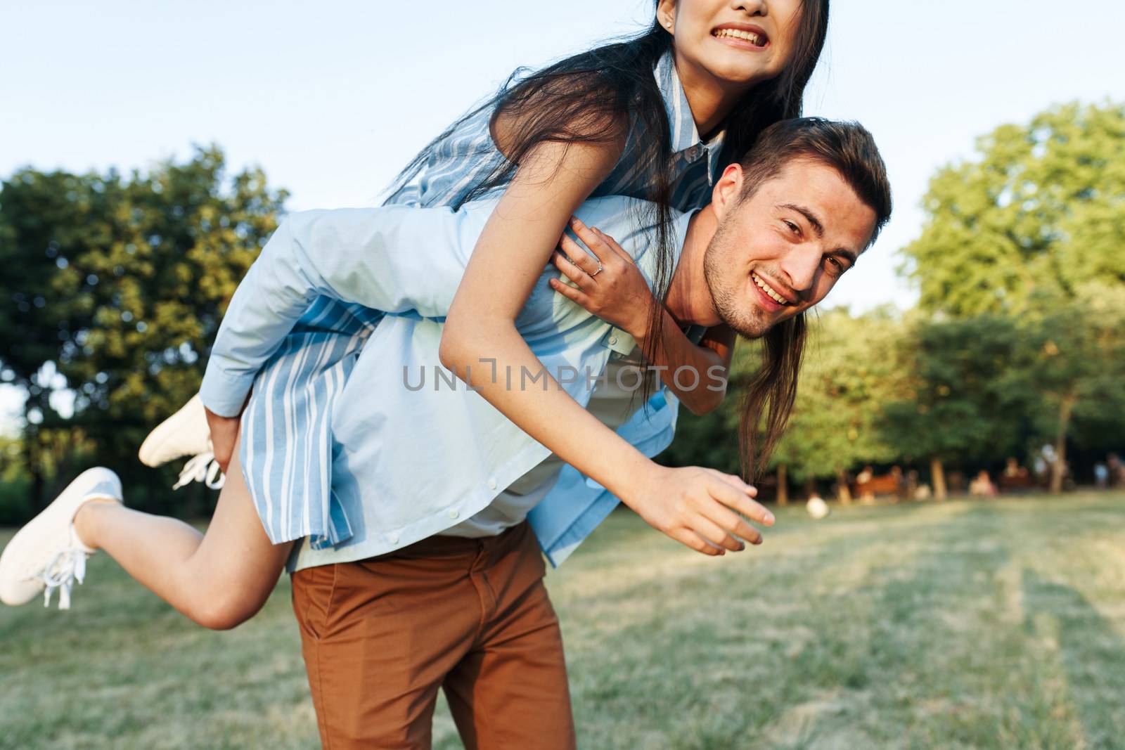 Cheerful young couple on nature walk the park fresh air