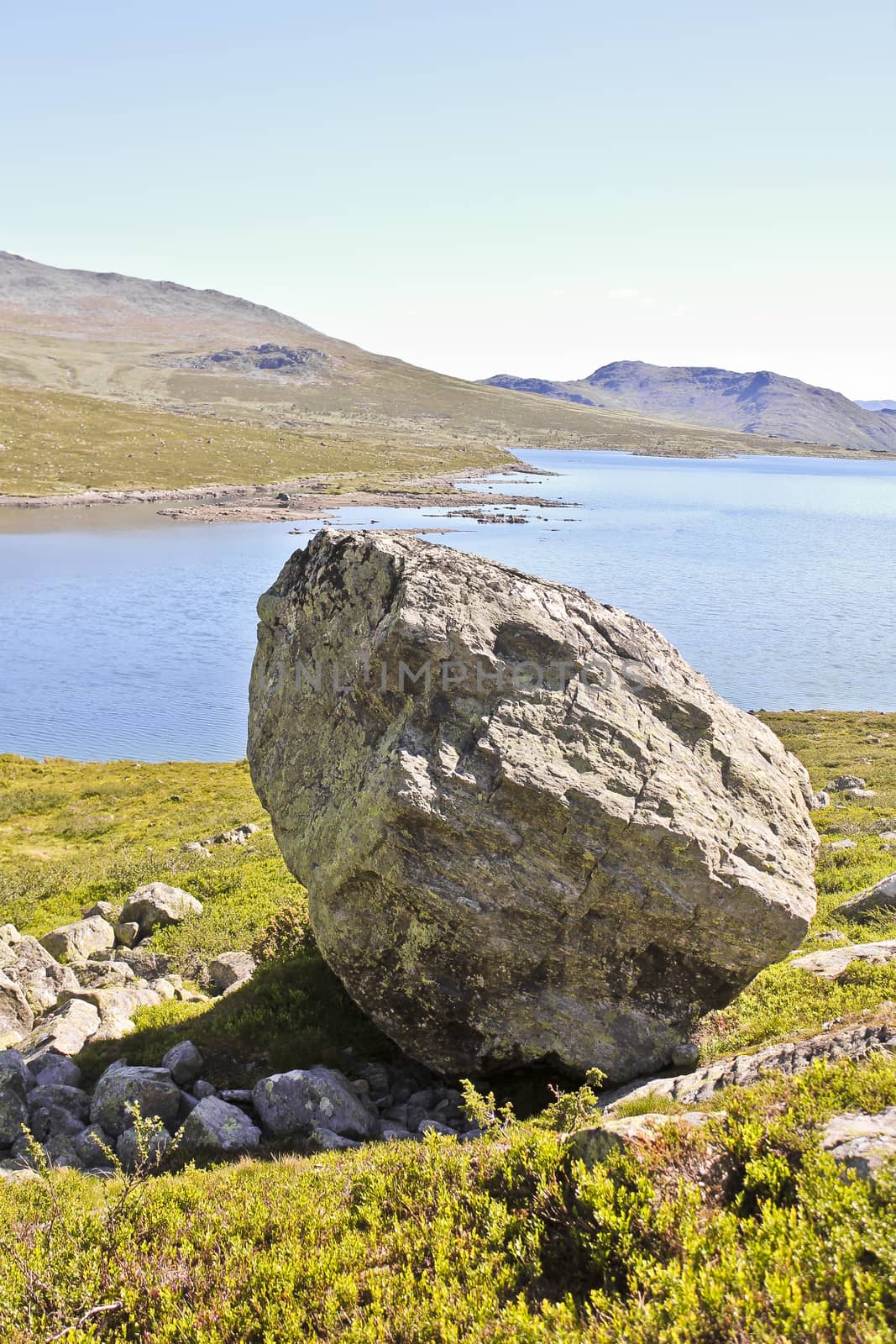 Huge boulder, big rock Vavatn lake in Hemsedal, Buskerud, Norway. by Arkadij