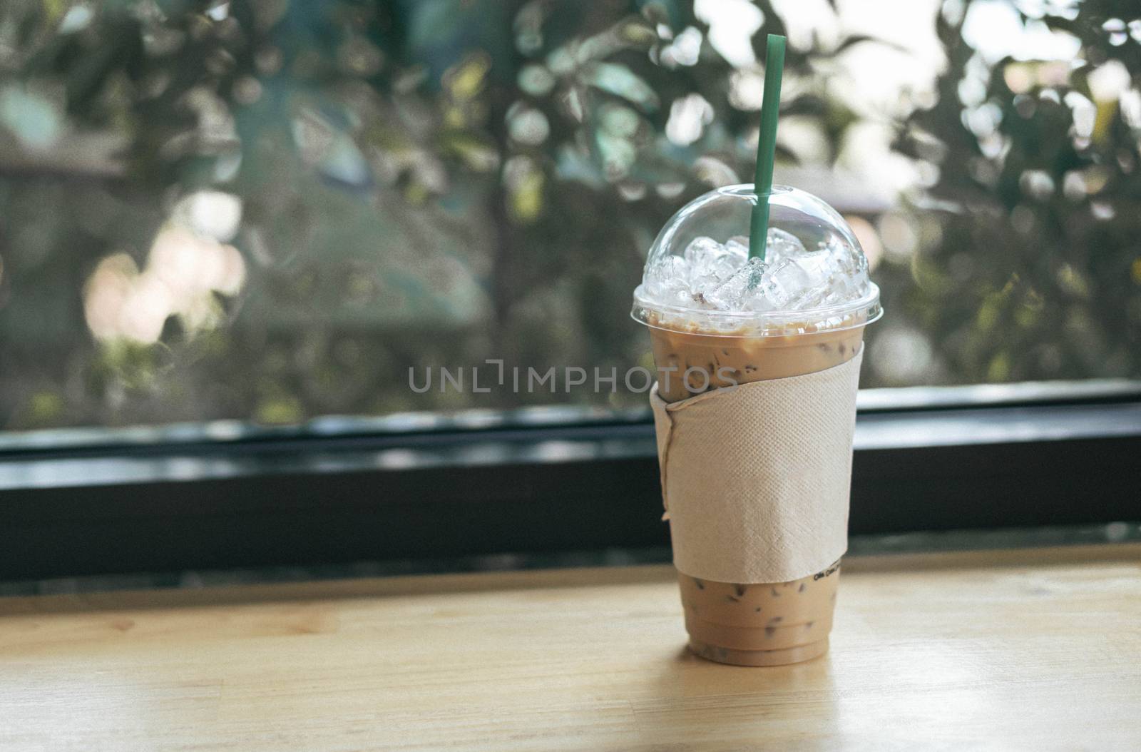 Close up glass of ice americano coffee on wood table, selective  by pt.pongsak@gmail.com