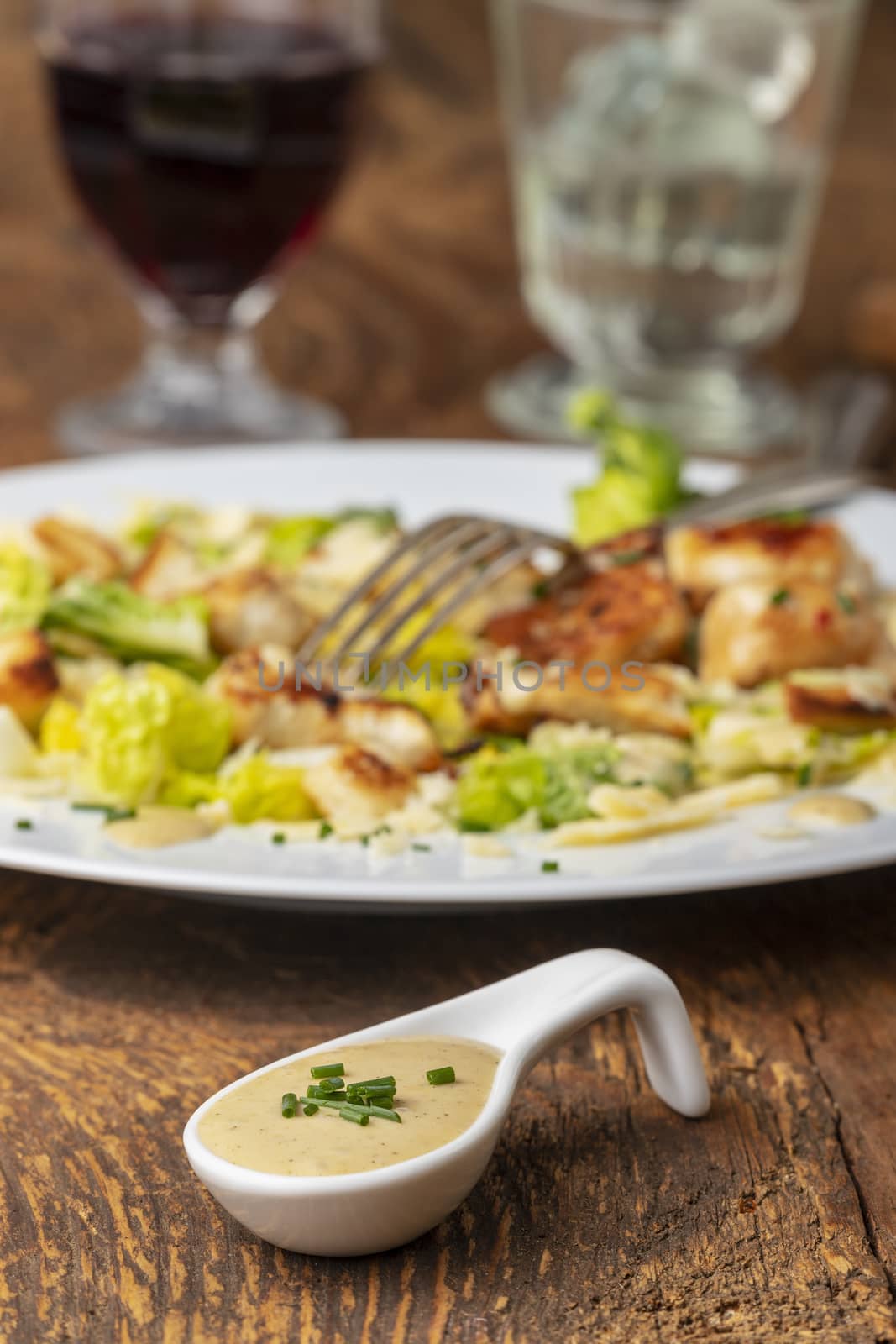 overview of a cesar salad on a plate by bernjuer