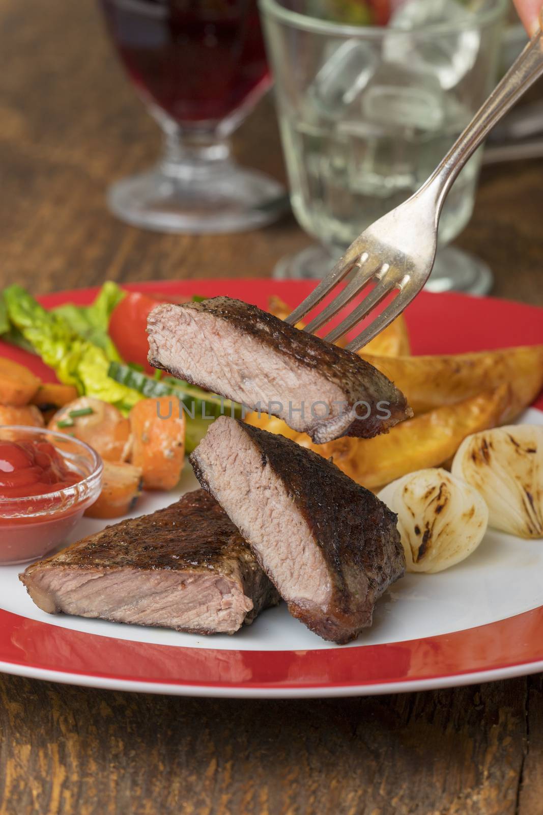 grilled steak on a plate with wine