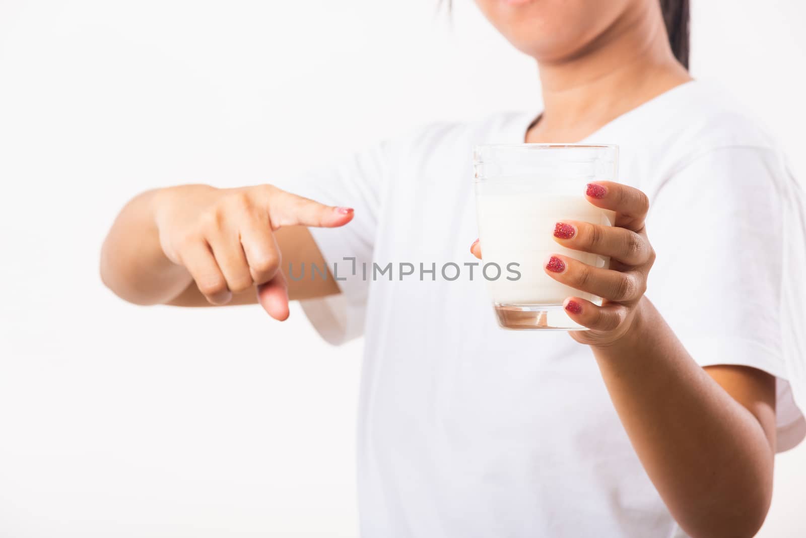 Asian portrait of happy young Asian beauty woman use hands hold drink white milk from a glass, studio shot isolated on white background, Food healthy care concept