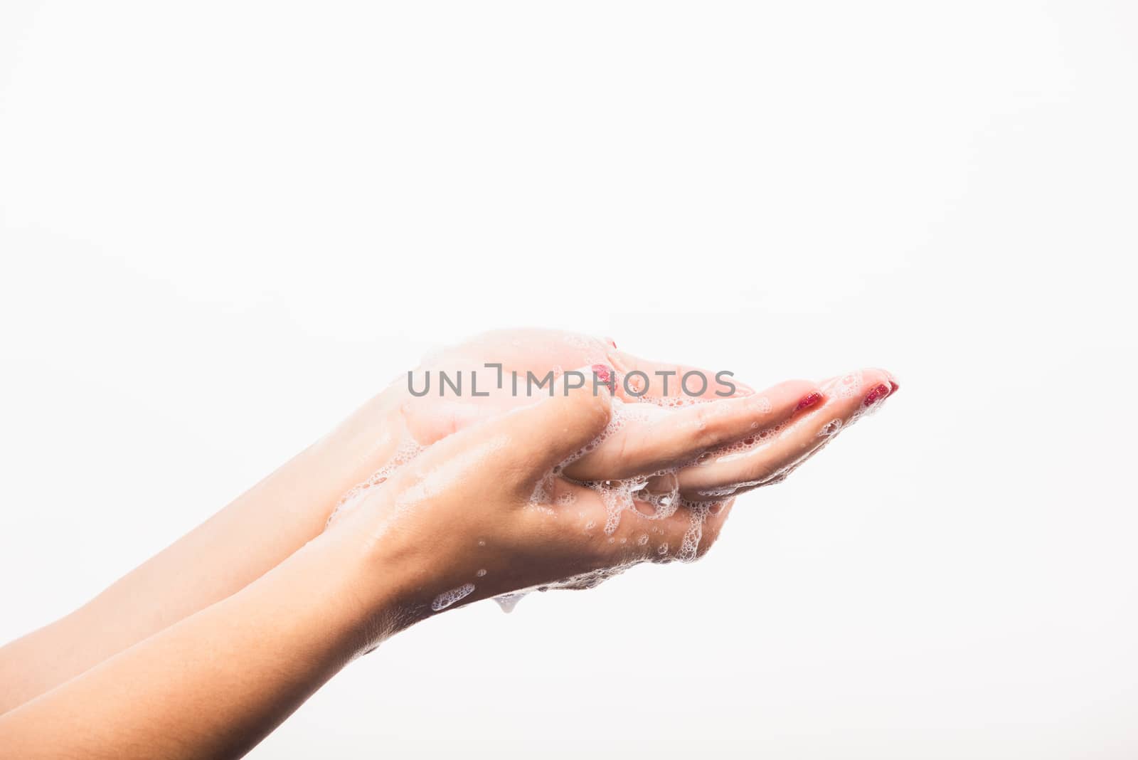 Closeup young Asian woman washing hands by soap for cleanliness and prevent germs coronavirus, studio shot isolated on white background, Healthcare medical COVID-19 virus concept