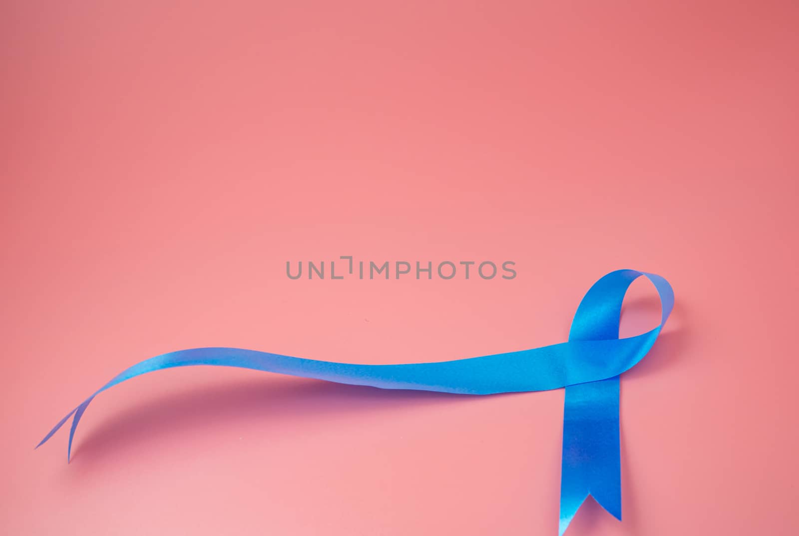 Blue ribbon symbol for  prostate cancer. by Unimages2527