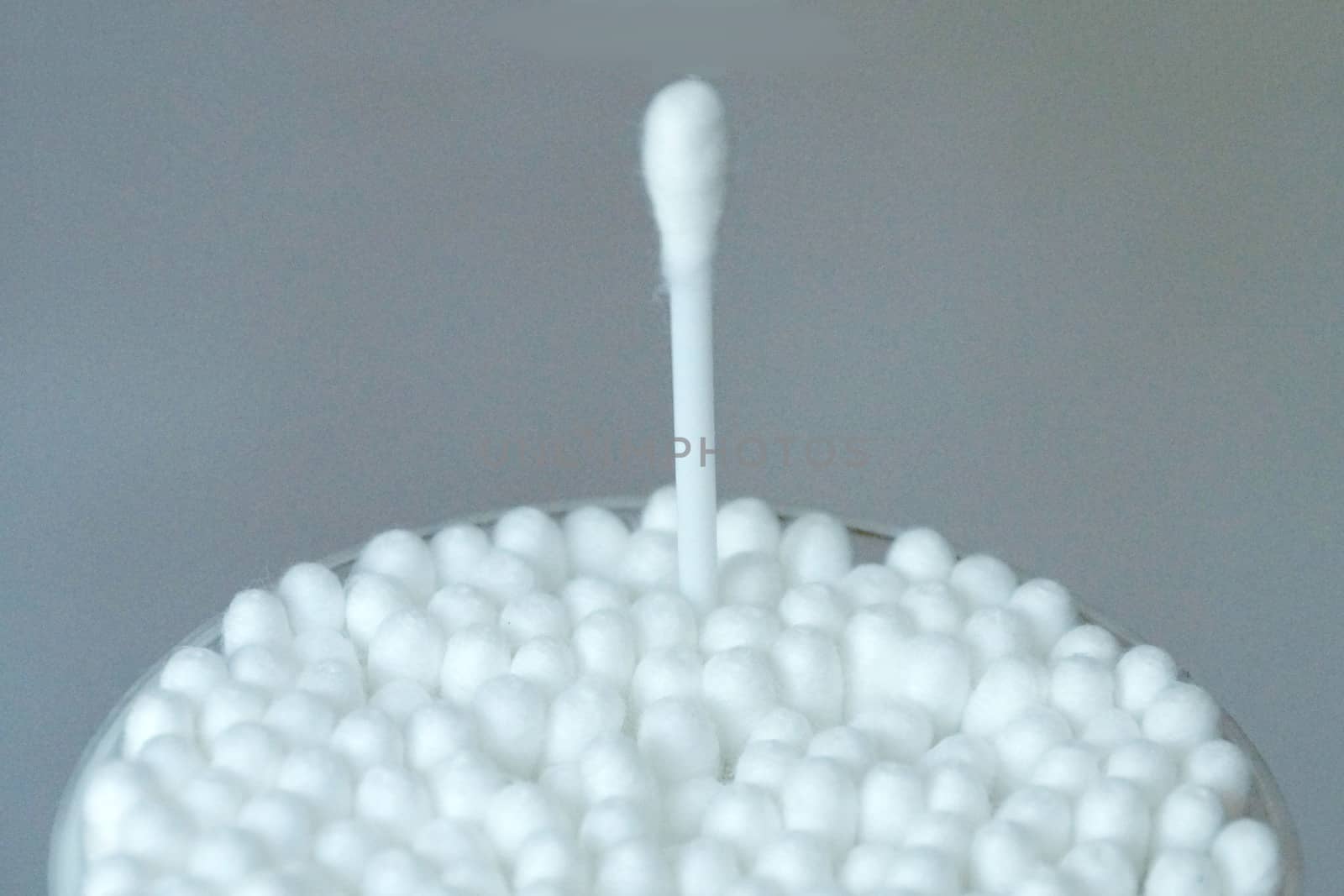 even packing of cotton swabs with one extended stick close-up