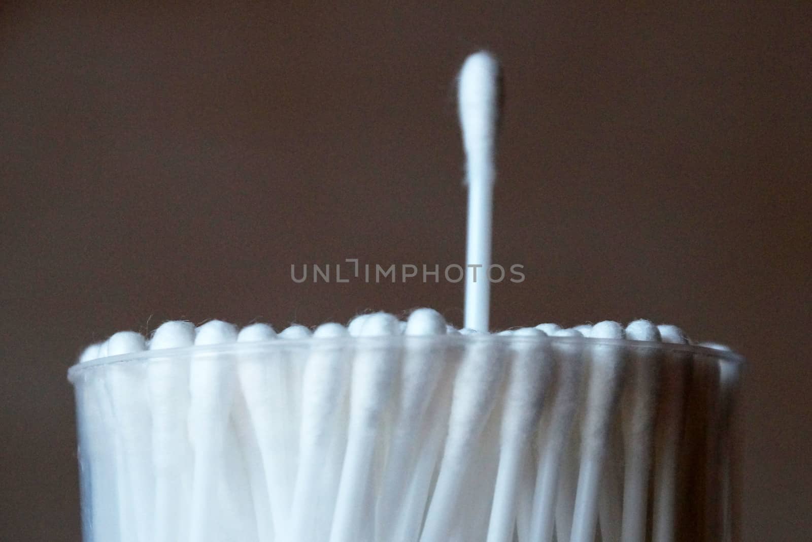 even packing of cotton swabs with one extended stick close-up