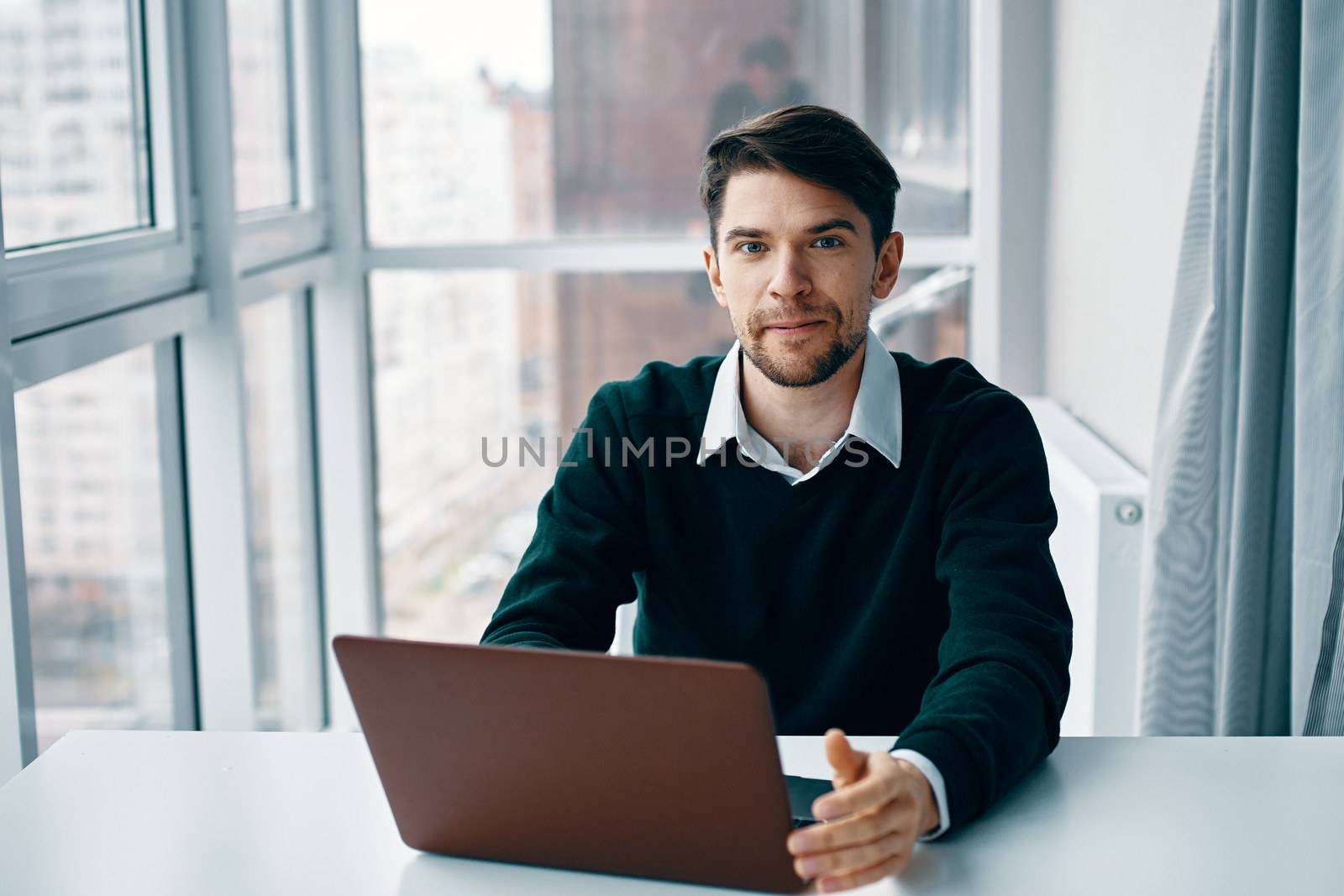 Handsome man with laptop in office model by SHOTPRIME