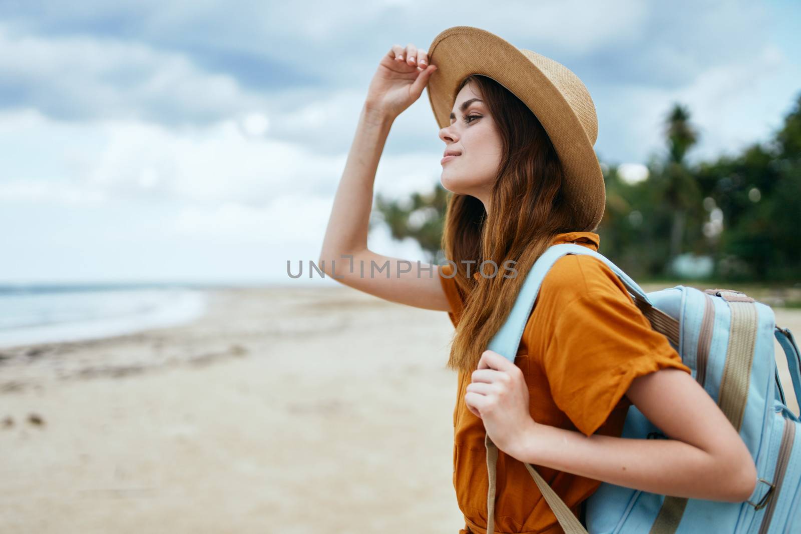 Confident traveler with a backpack on a desert island