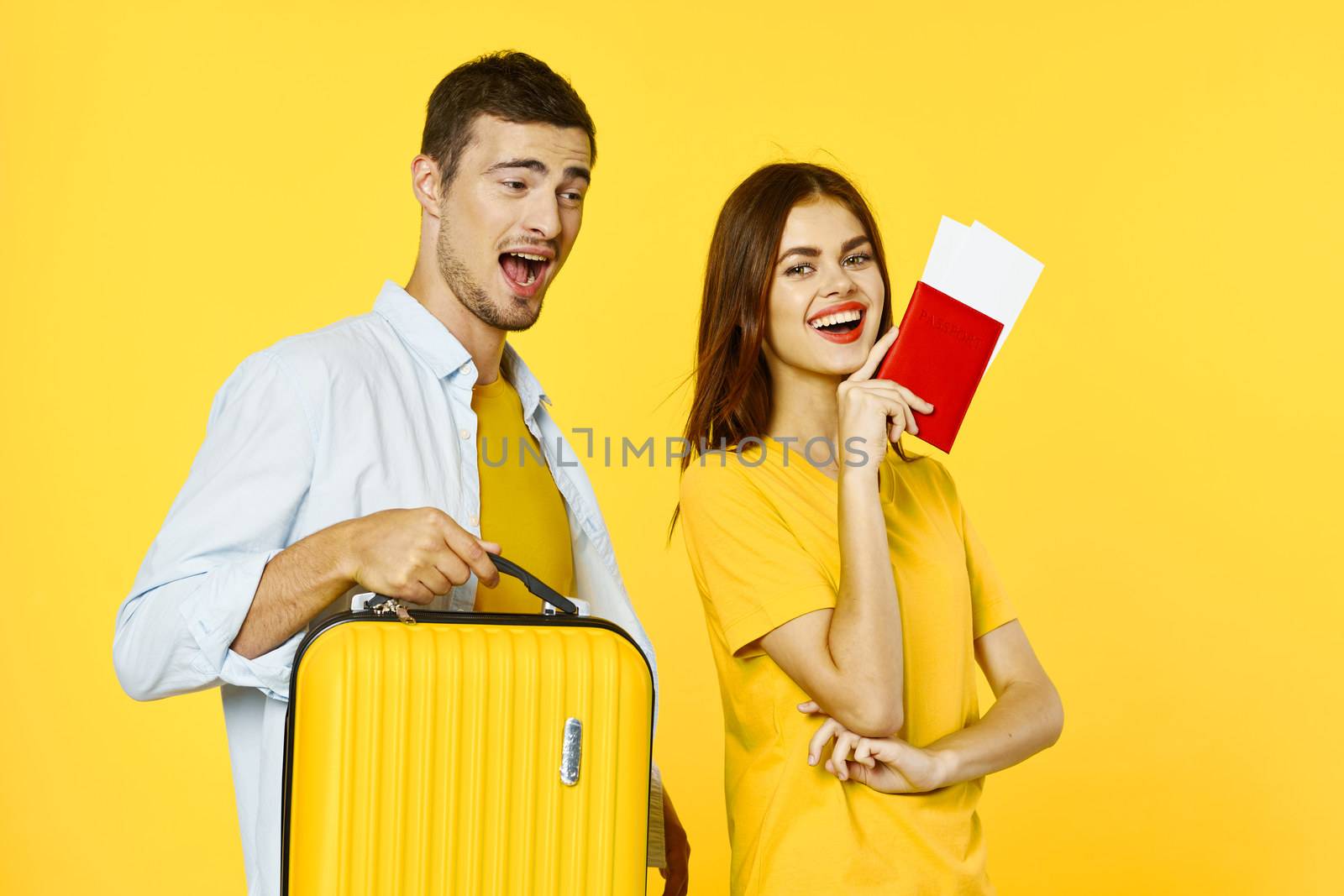 Loving couple go on a trip and a yellow suitcase passport tickets model