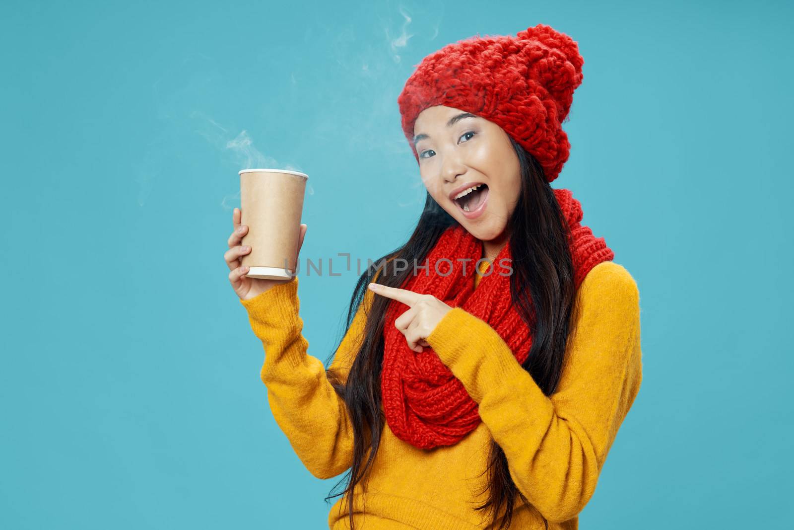 Happy woman with a hot drink in hand and warm clothes a cup of coffee