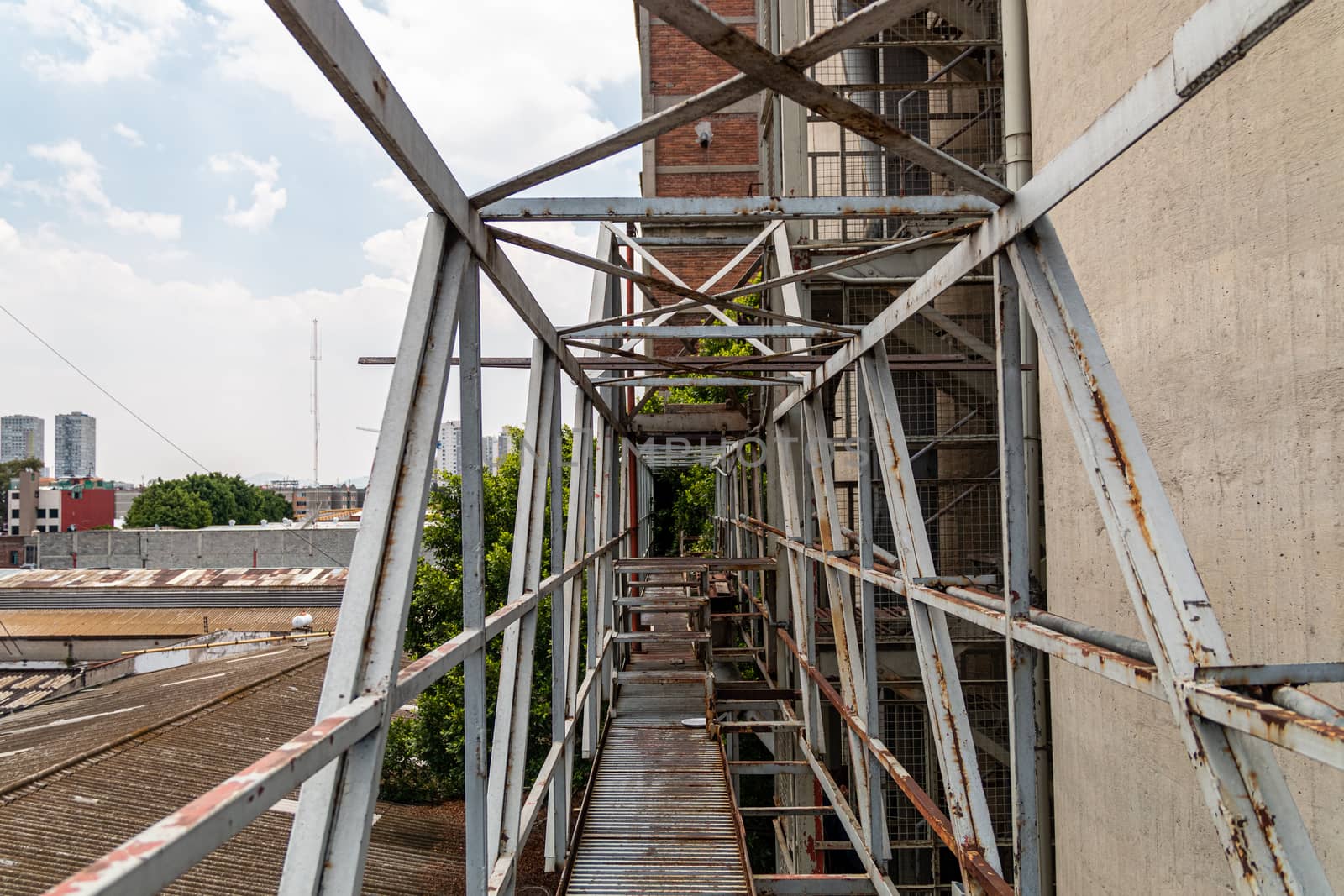 Pedestrian overpass in old factory. rusty metal, dangerous place. Metal structure