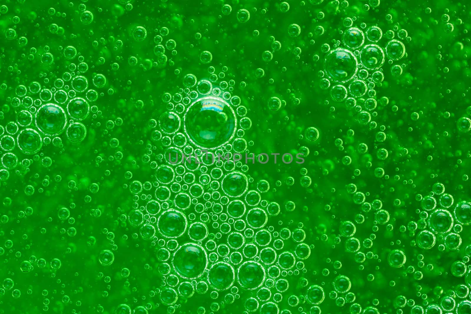 abstract liquid soap bubbles green background