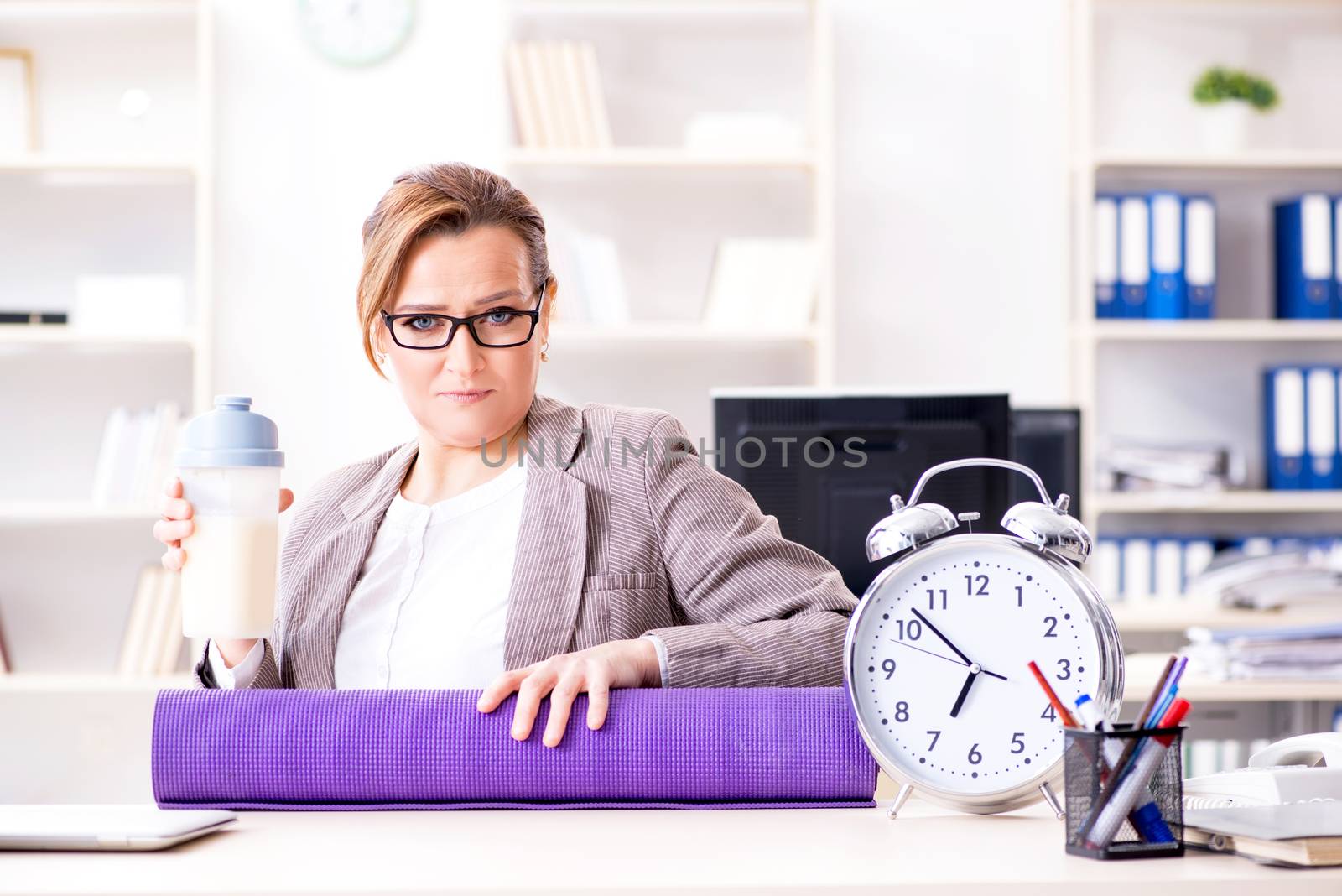Woman employee going to sports from work during lunch break by Elnur