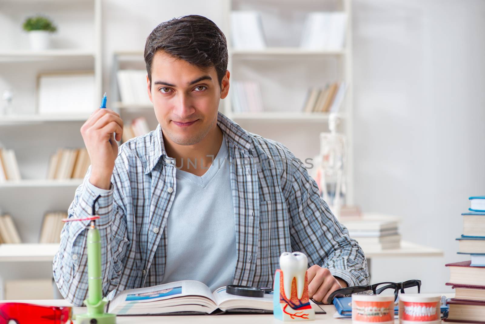 Medical student learning dentistry in classroom