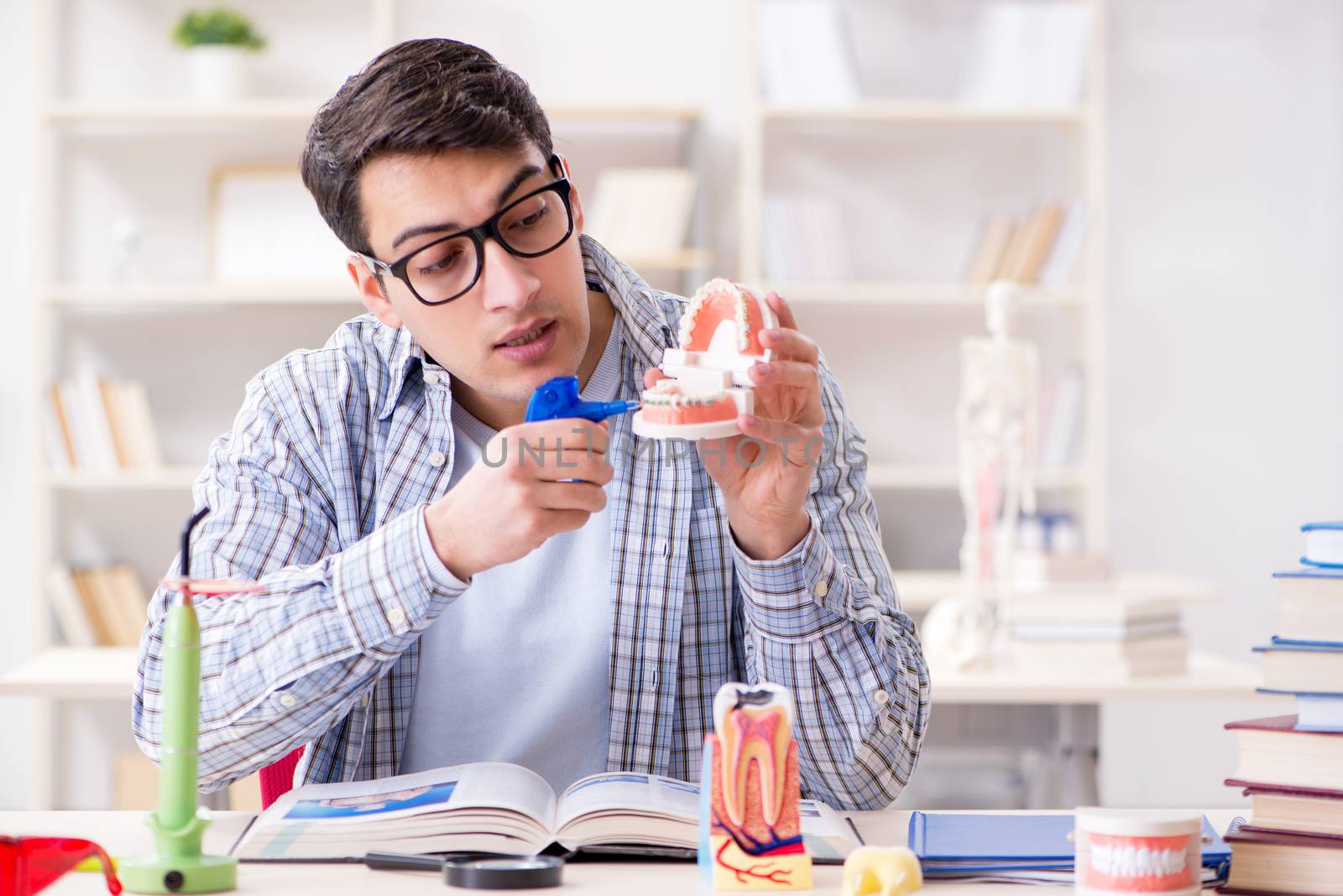 Medical student learning dentistry in classroom