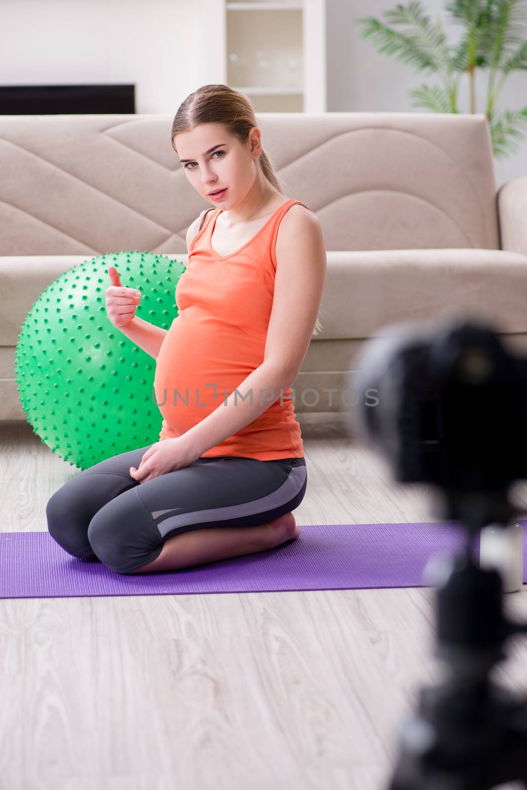 Pregnant woman recording video for blog and vlog by Elnur