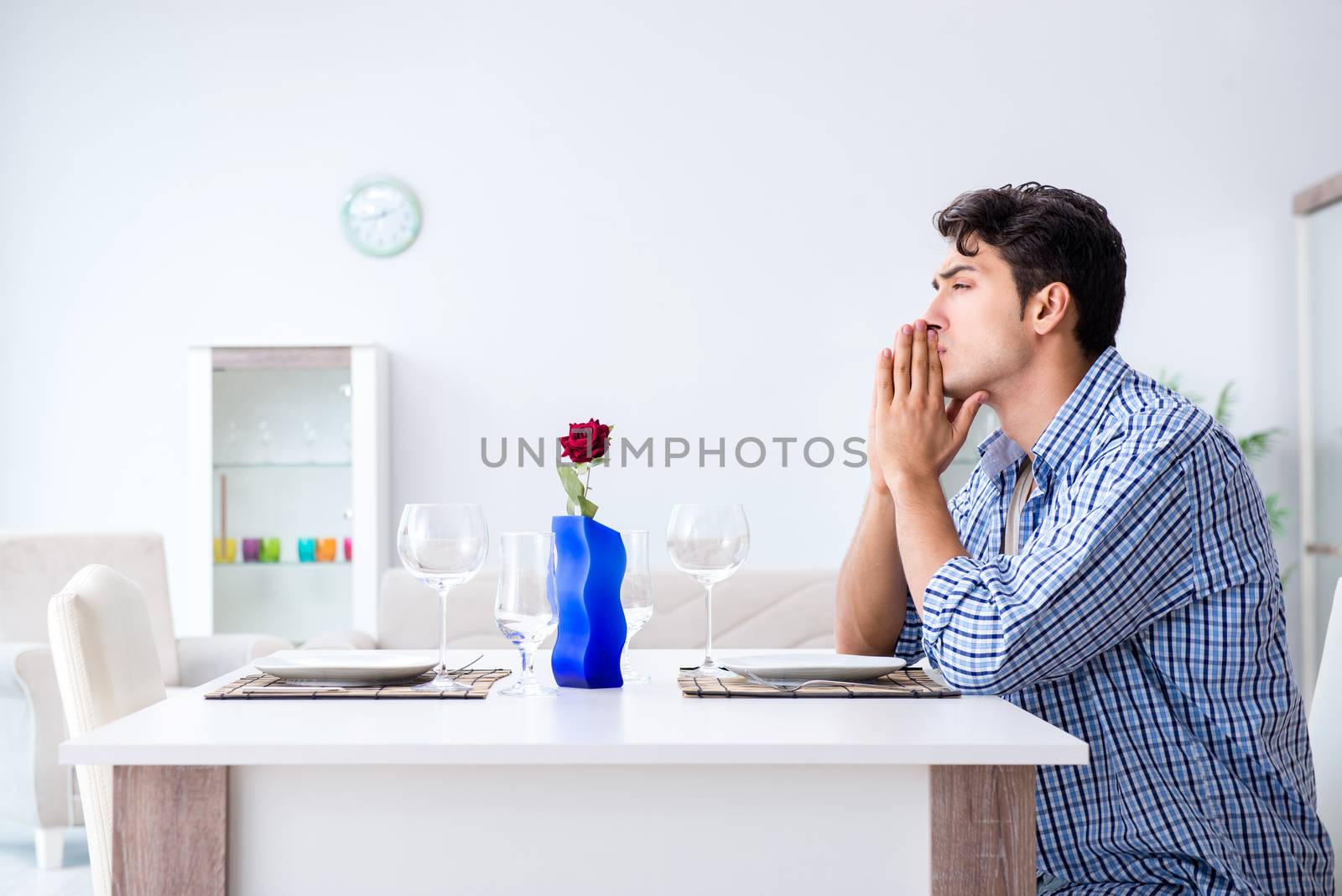 Man alone preparing for romantic date with his sweetheart