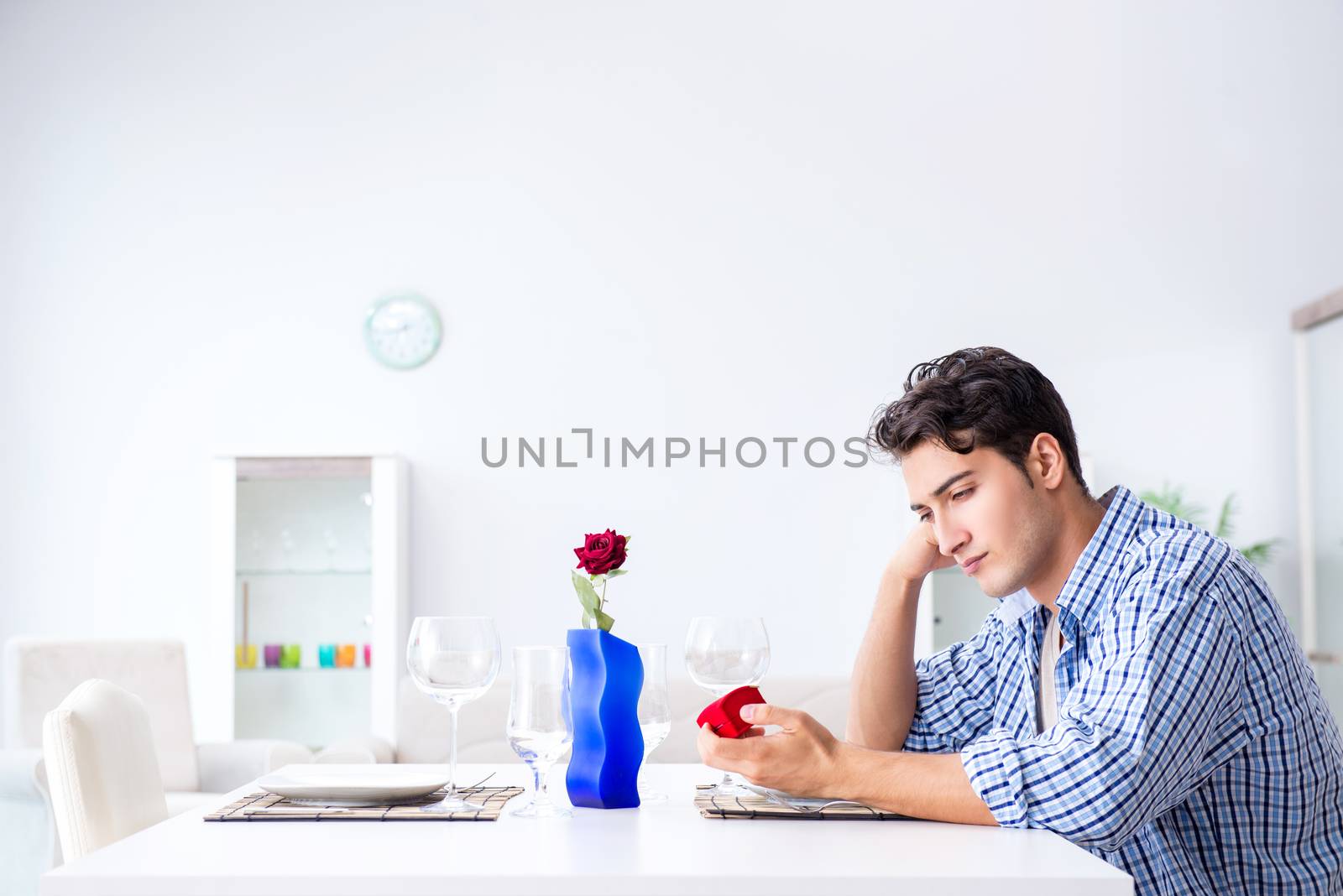 Man alone preparing for romantic date with his sweetheart