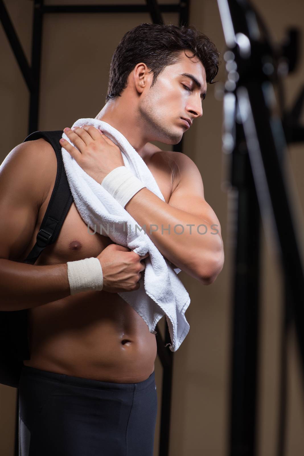 Man tired after workout in sports gym