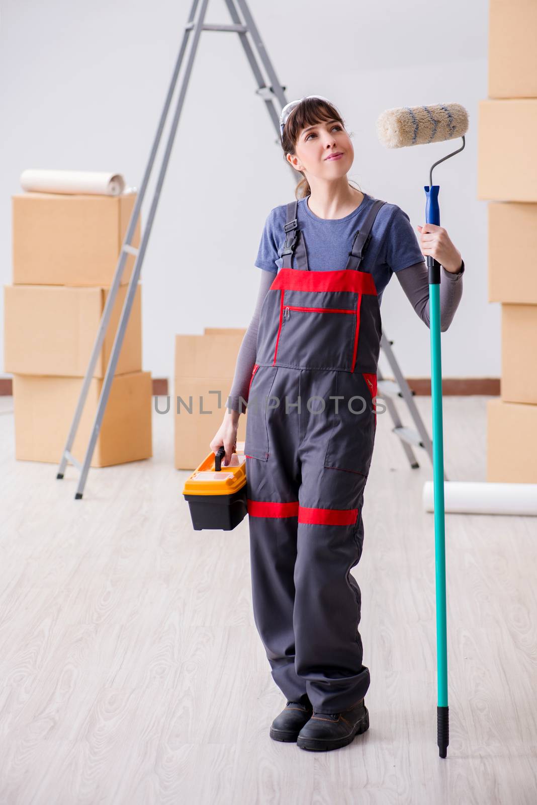 Woman painter painting in new apartment