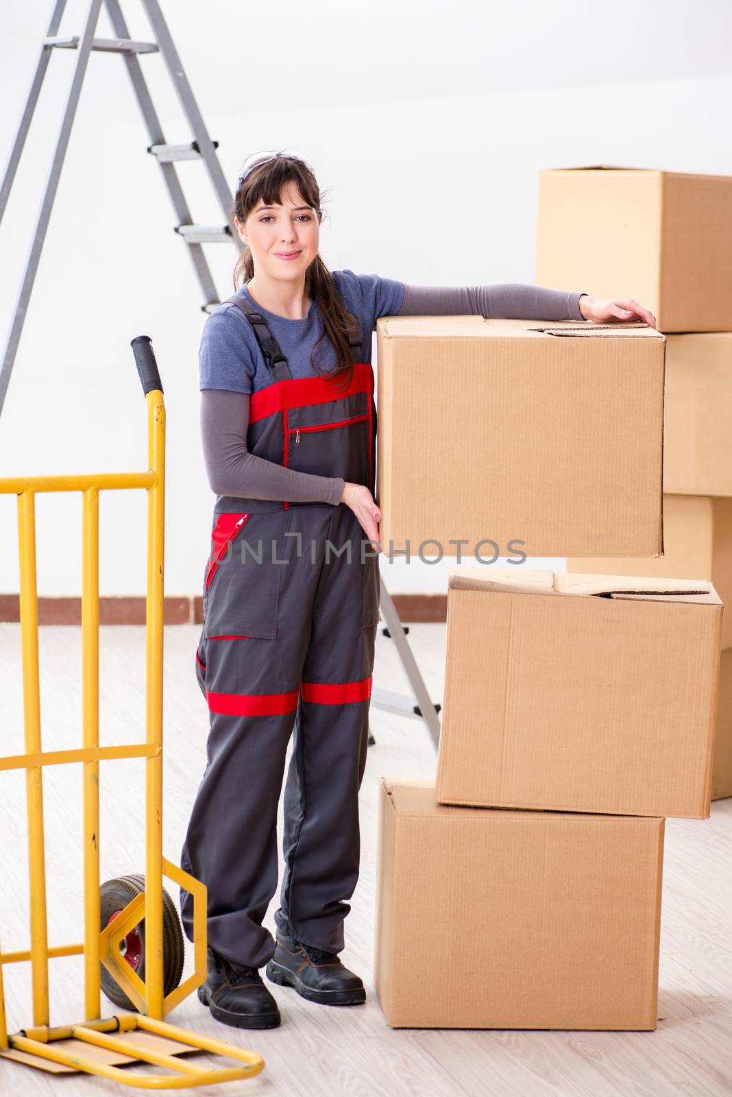 Woman contractor moving boxes in relocation concept
