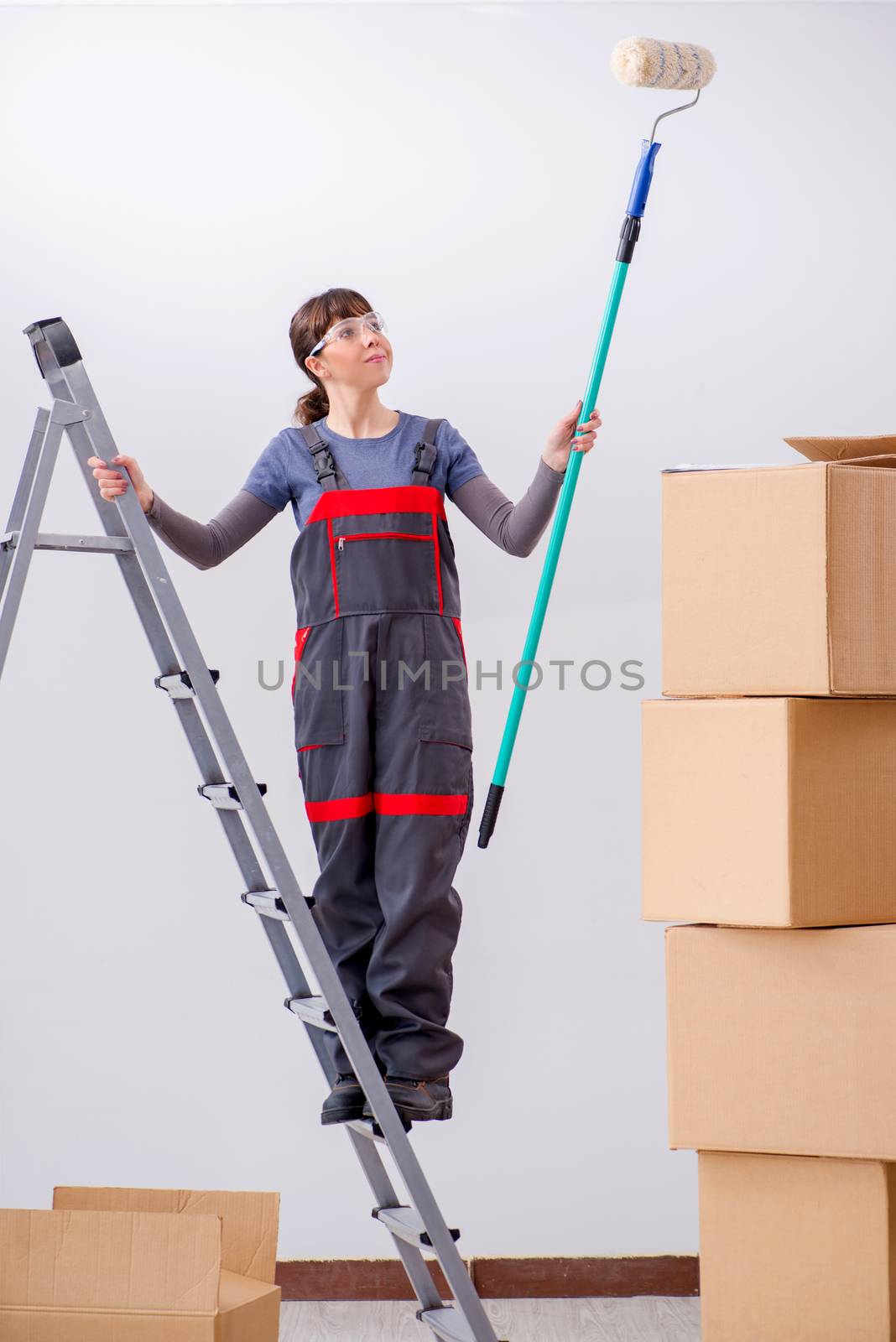 Woman painter painting in new apartment