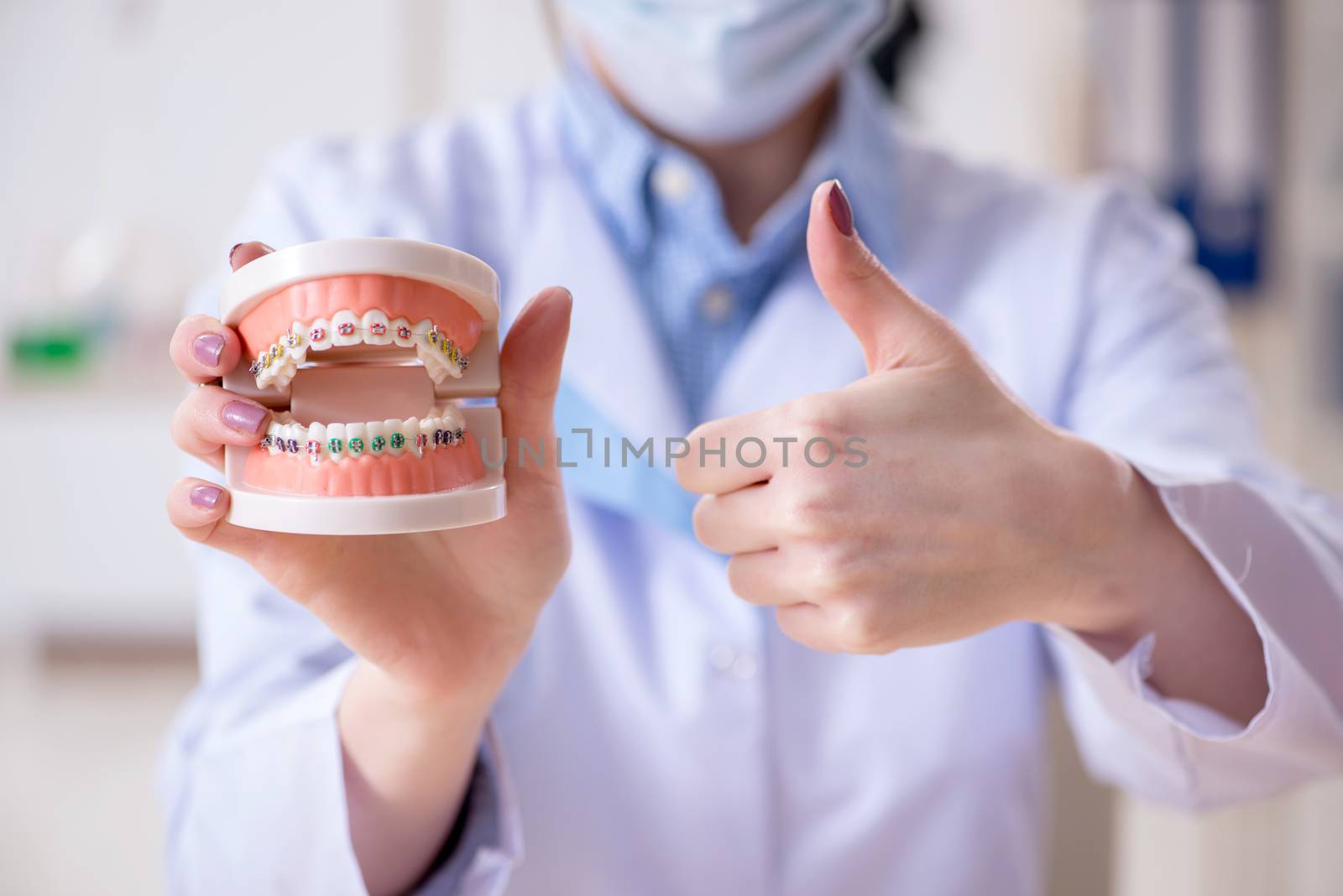 Dentist practicing work on tooth model by Elnur