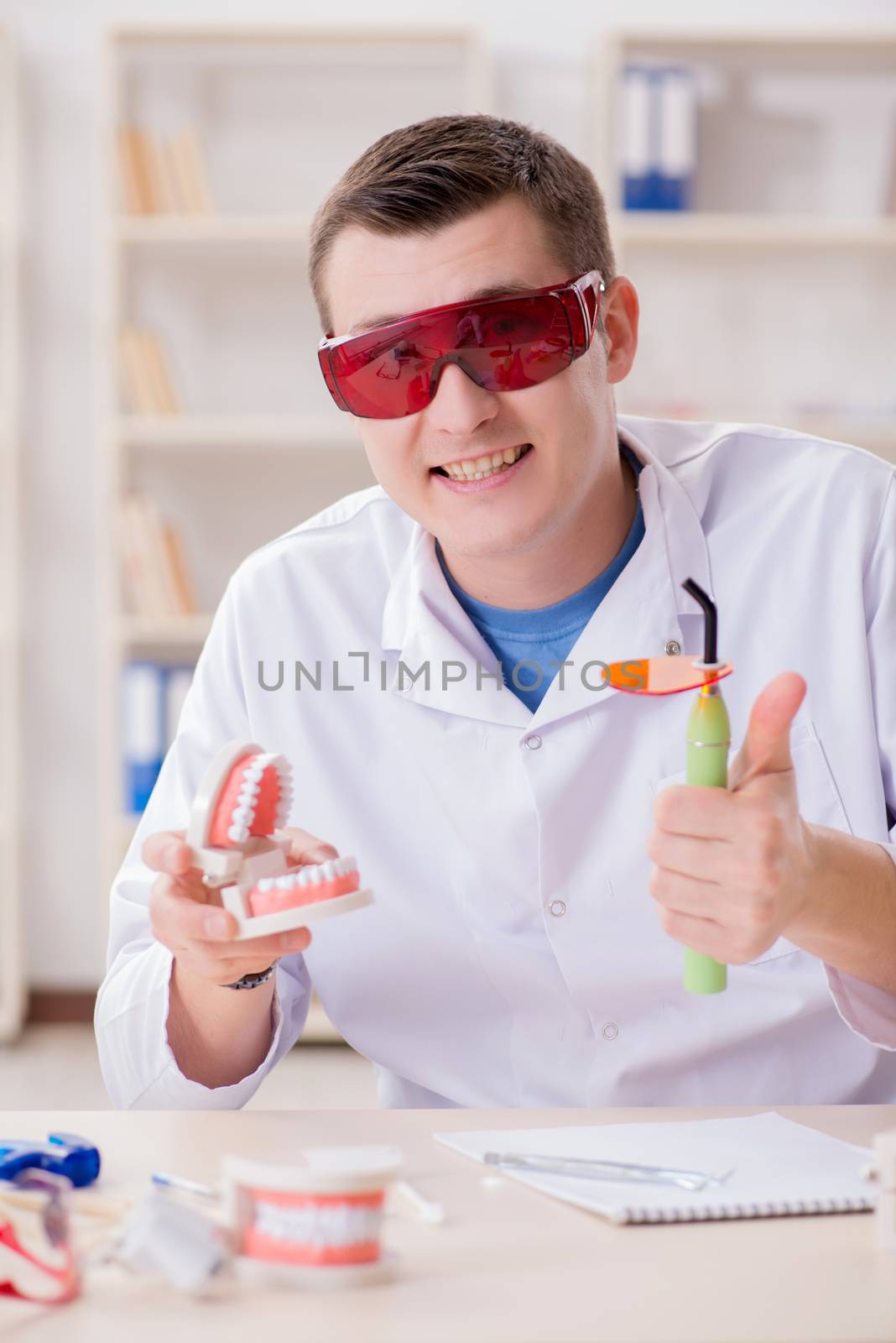 Dentist working teeth implant in medical lab