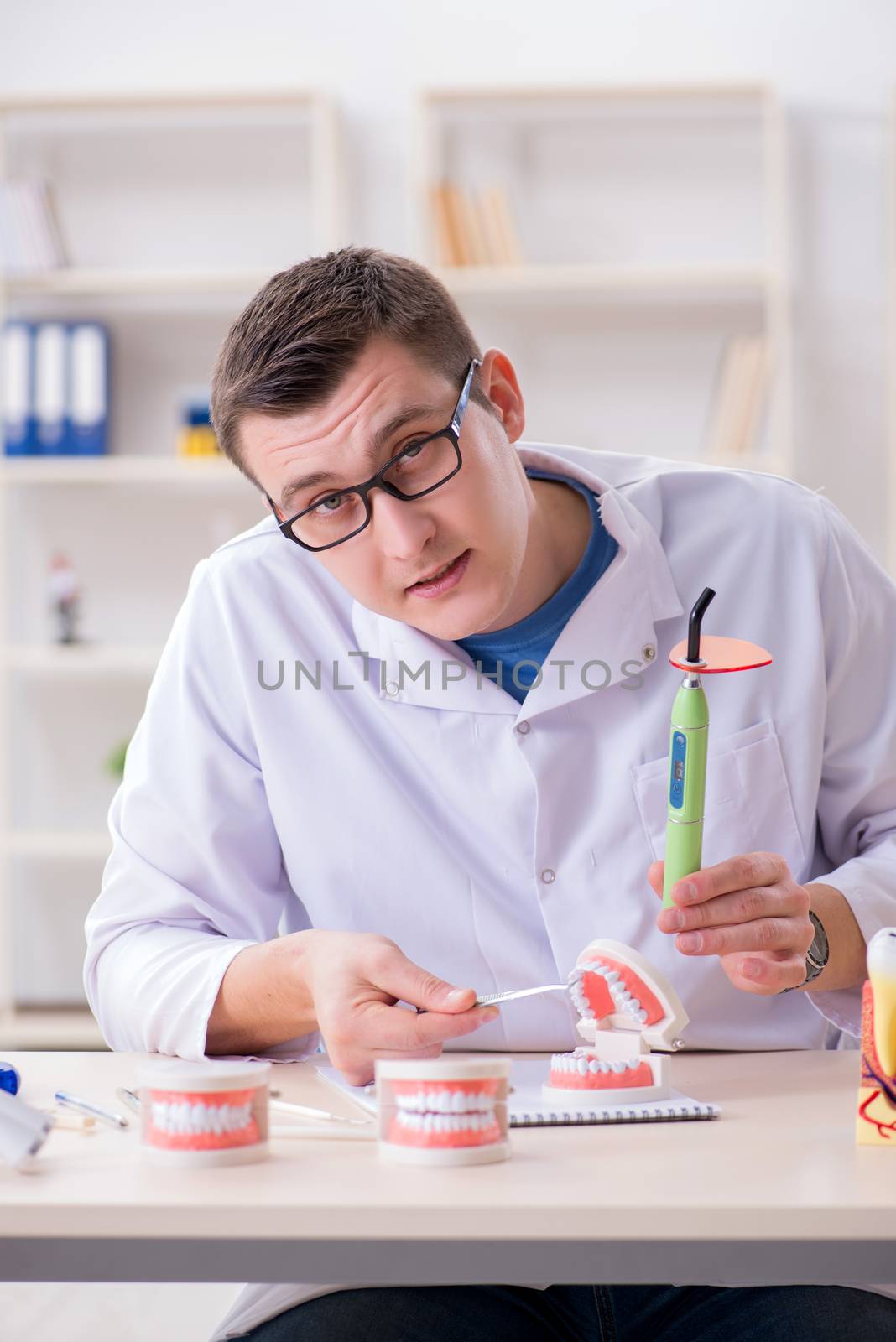 Dentist working teeth implant in medical lab