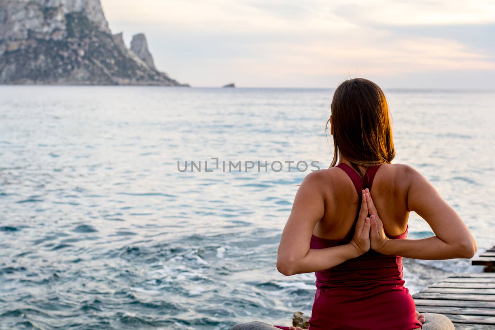 Attractive woman practice yoga at beach with sunset or sunrise in Es Vedra, Ibiza, Spain. by martinscphoto