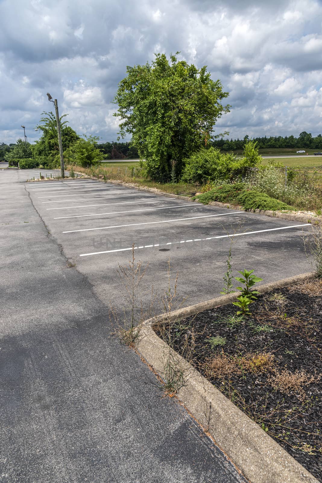 Horizontal shot of the empty customer parking lot of a failed restaurant after the Pandemic.