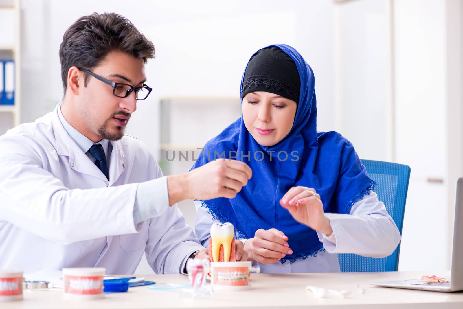 Dentist doctor and assistant working on new tooth implant