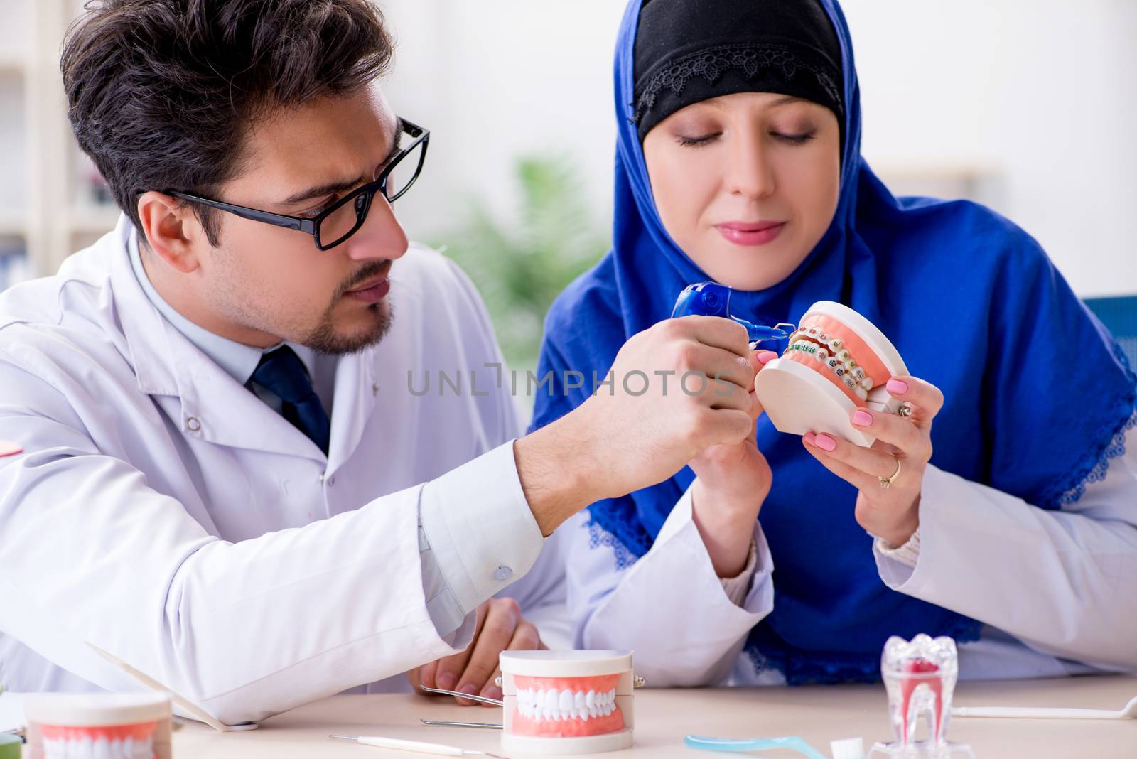 Dentist doctor and assistant working on new tooth implant