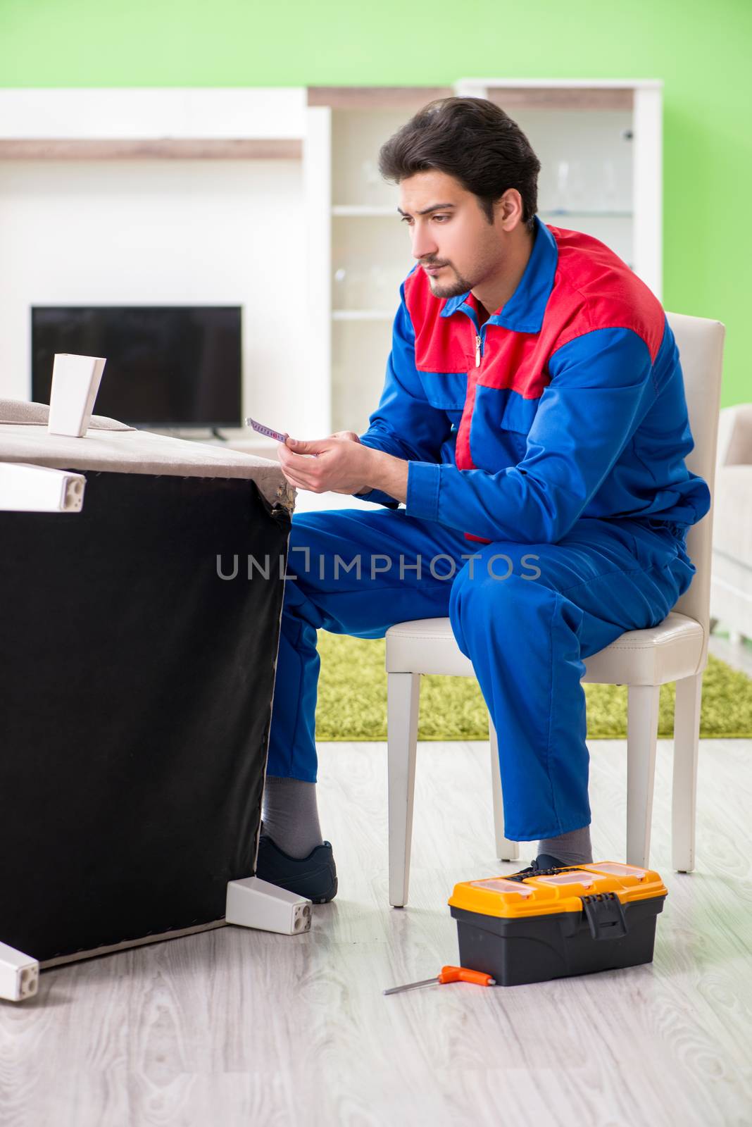 Repair contractor repairing broken furniture at home