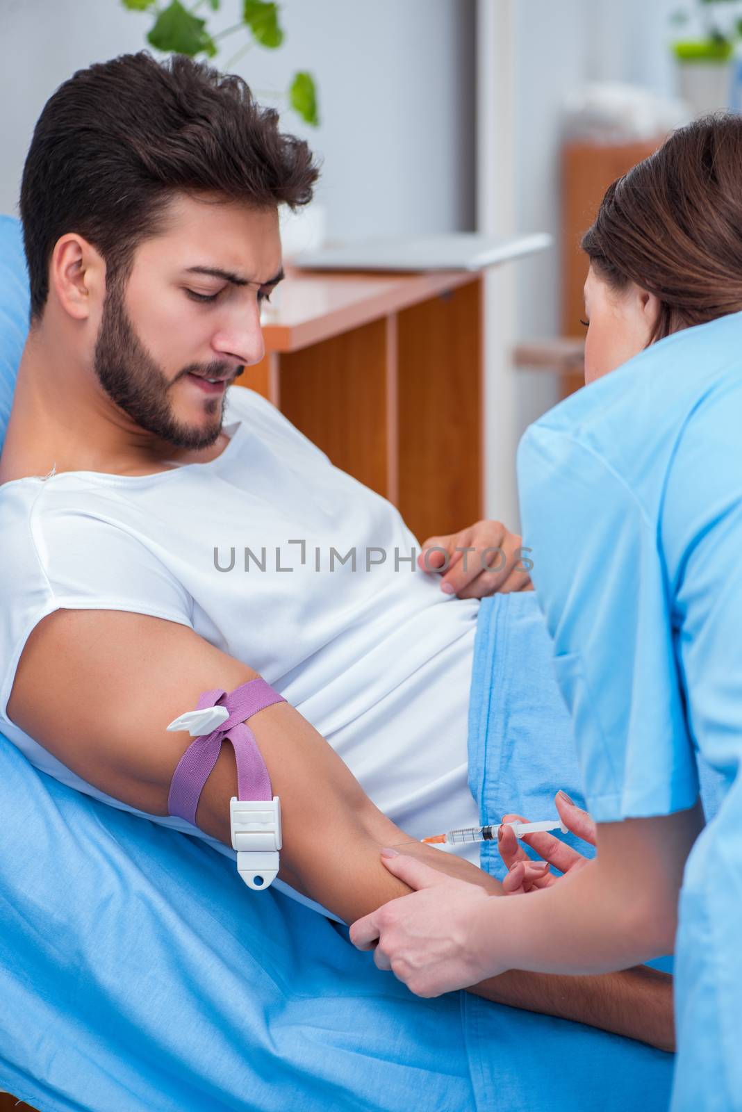 Woman doctor examining male patient in hospital