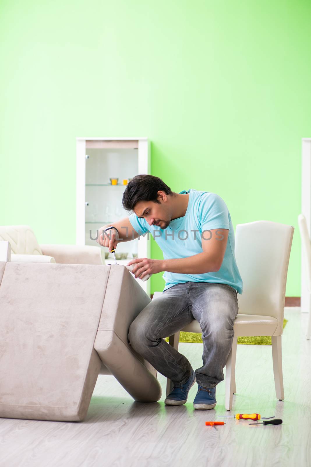 Man repairing furniture at home