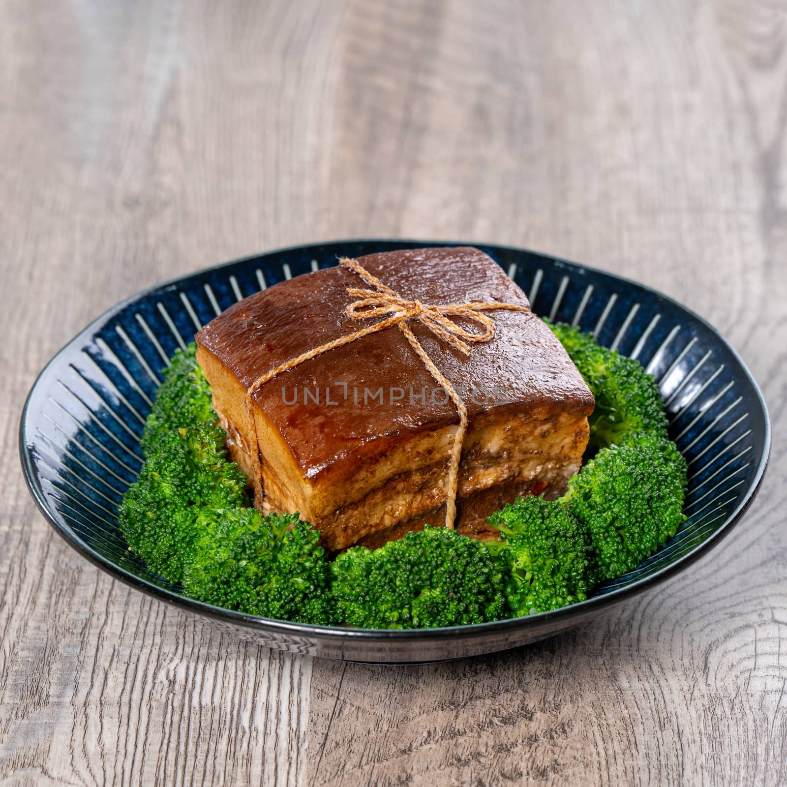 Dong Po Rou (Dongpo pork meat) in a beautiful blue plate with gr by ROMIXIMAGE
