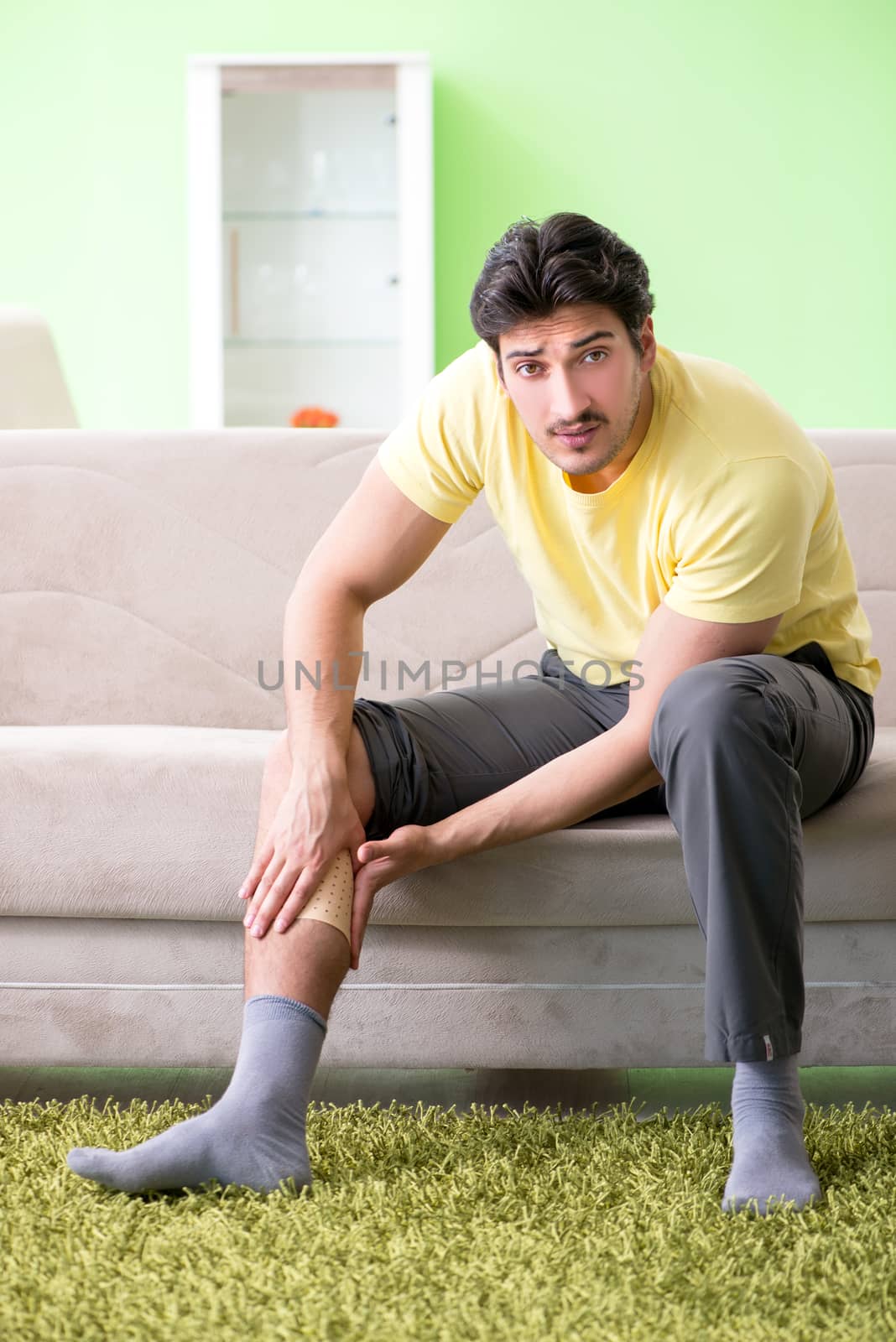 Man applying pepper Capsicum plaster to relieve pain