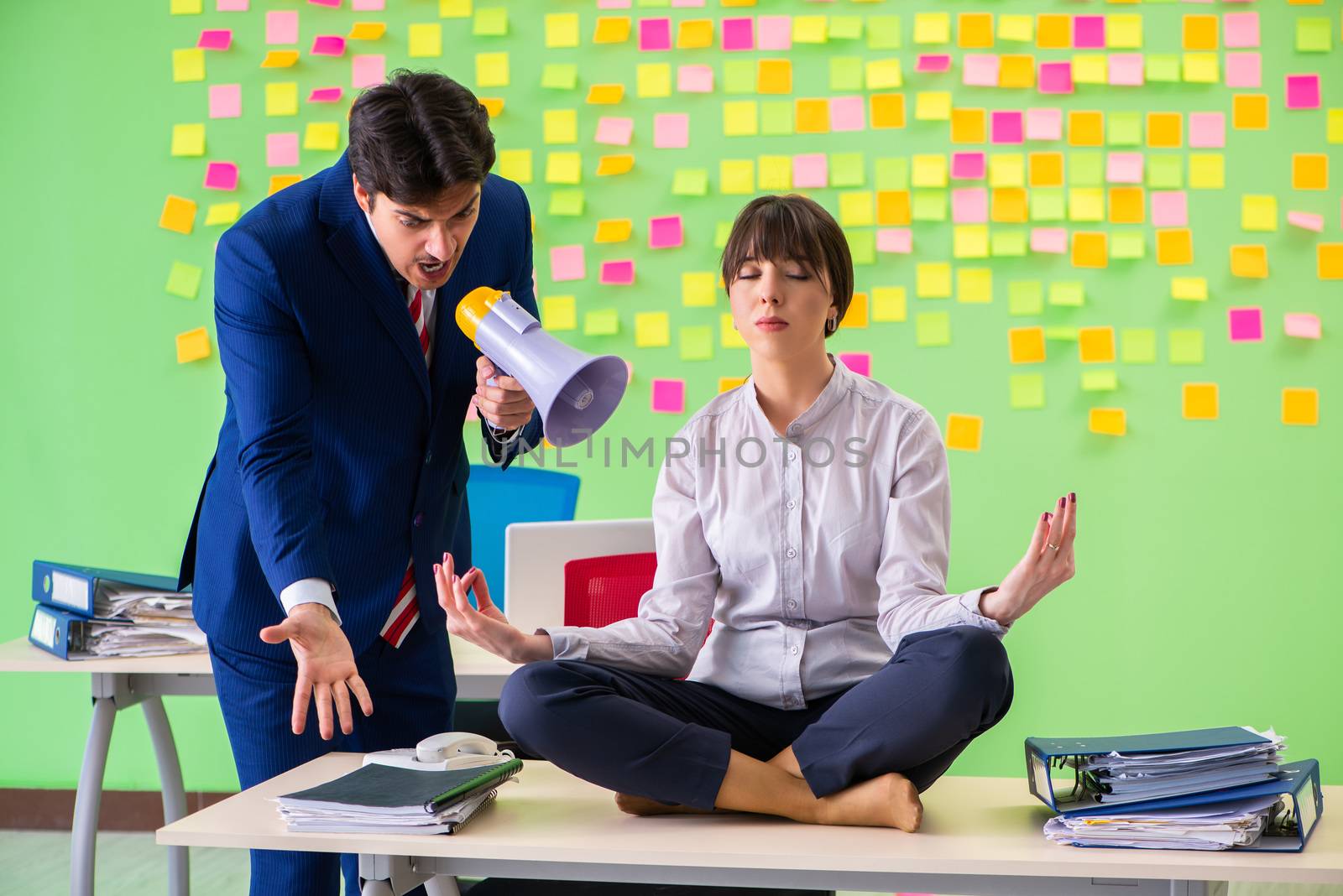 Man and woman in the office with many conflicting priorities in  by Elnur