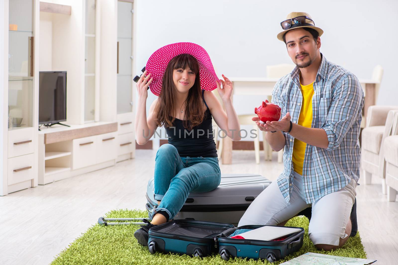 Young family packing for vacation travel by Elnur