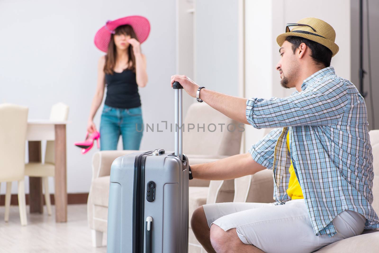 Young family packing for vacation travel