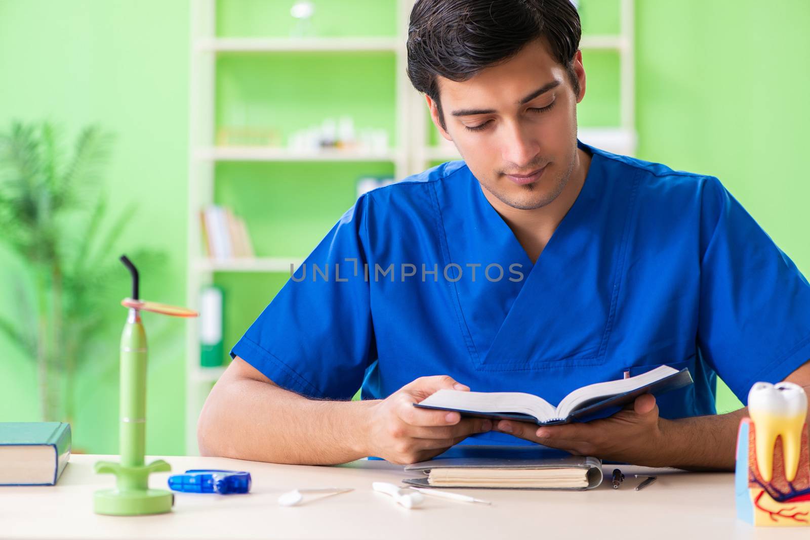 Dentist doctor reading book in the clinic  